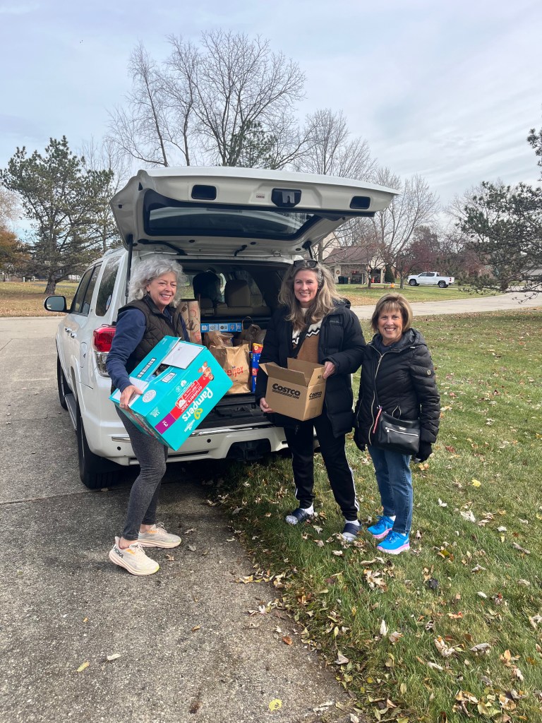Residents loading up a car with food for food drive.