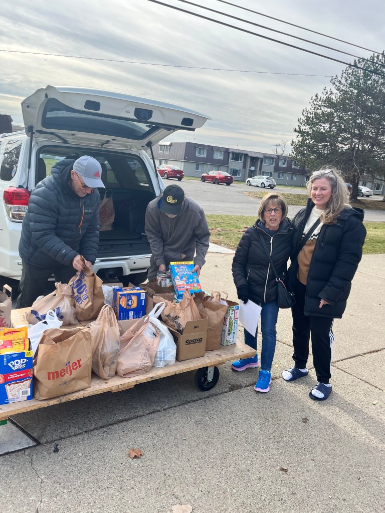 Residents unloading donations for CARES of Farmington Hills